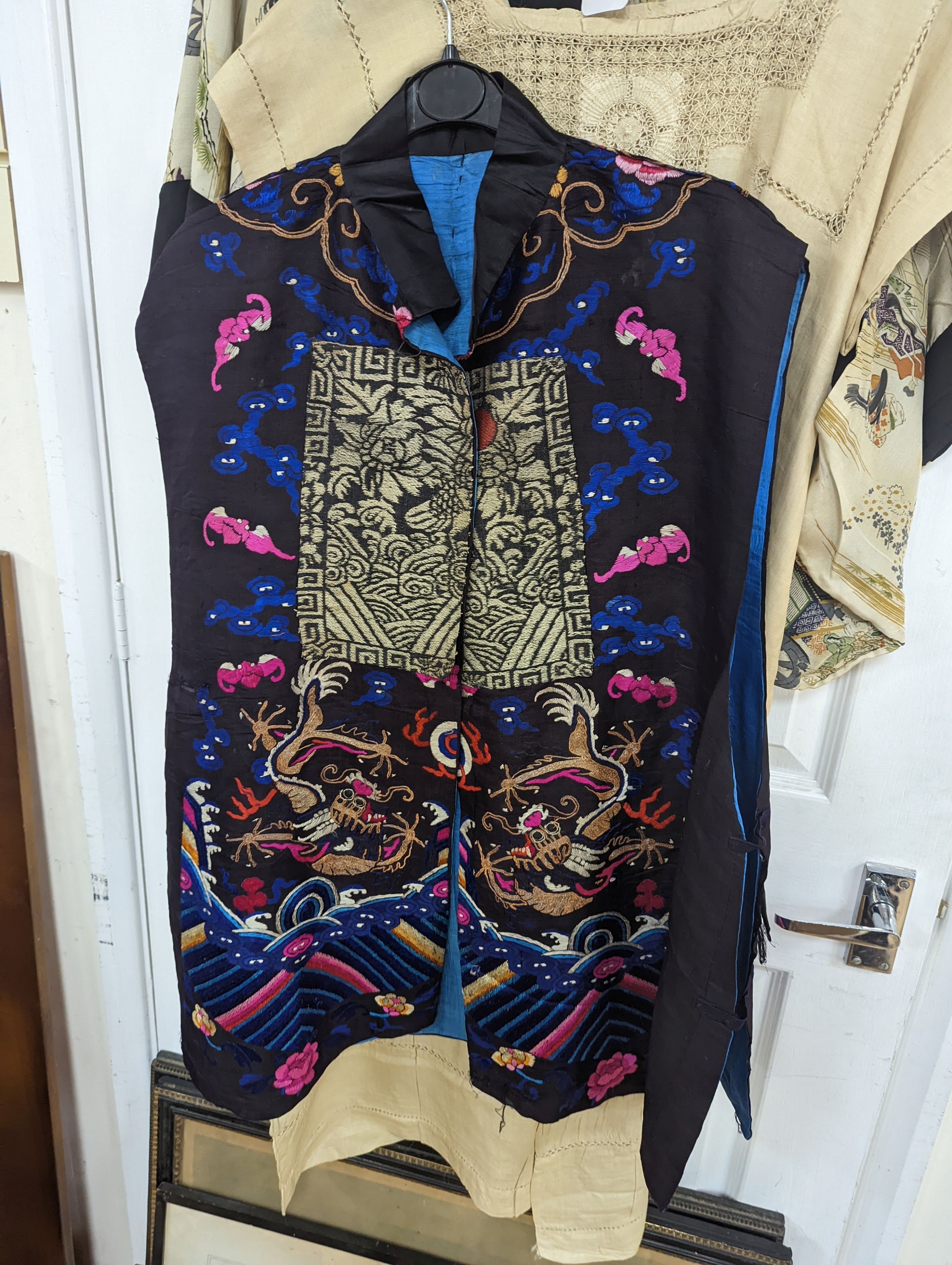 A 1920's Chinese dragon embroidered waistcoat, a cream silk drawn thread dress and a silk crepe black and patterned reversible kimono (3 items).